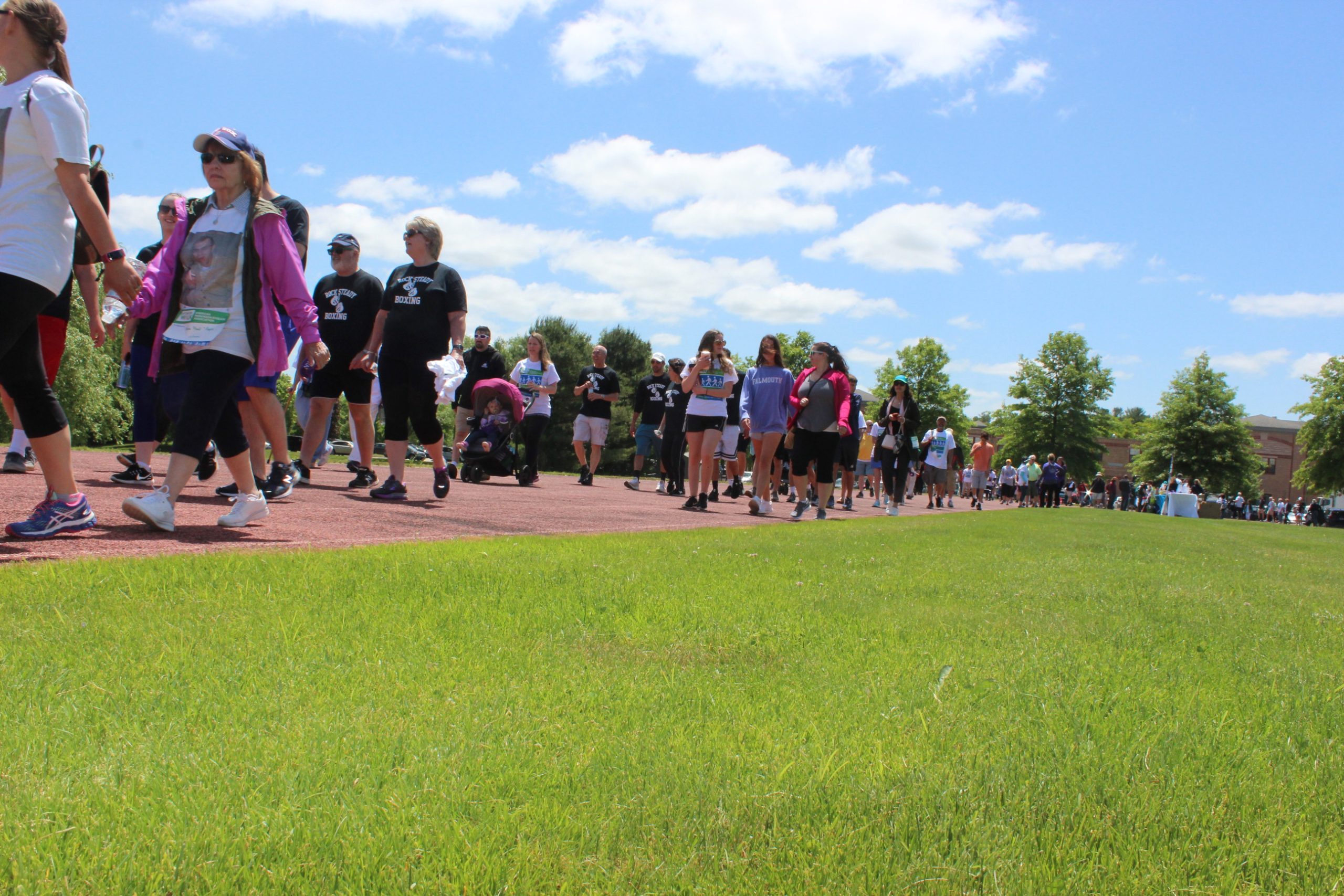 Large group of people walking around the track during a past event