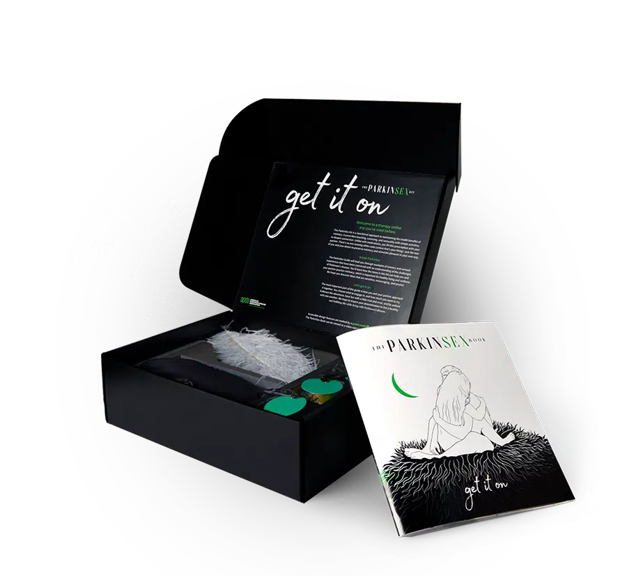 Photograph of the open ParkinSex box, with a feather and the ParkinSex booklet displayed.