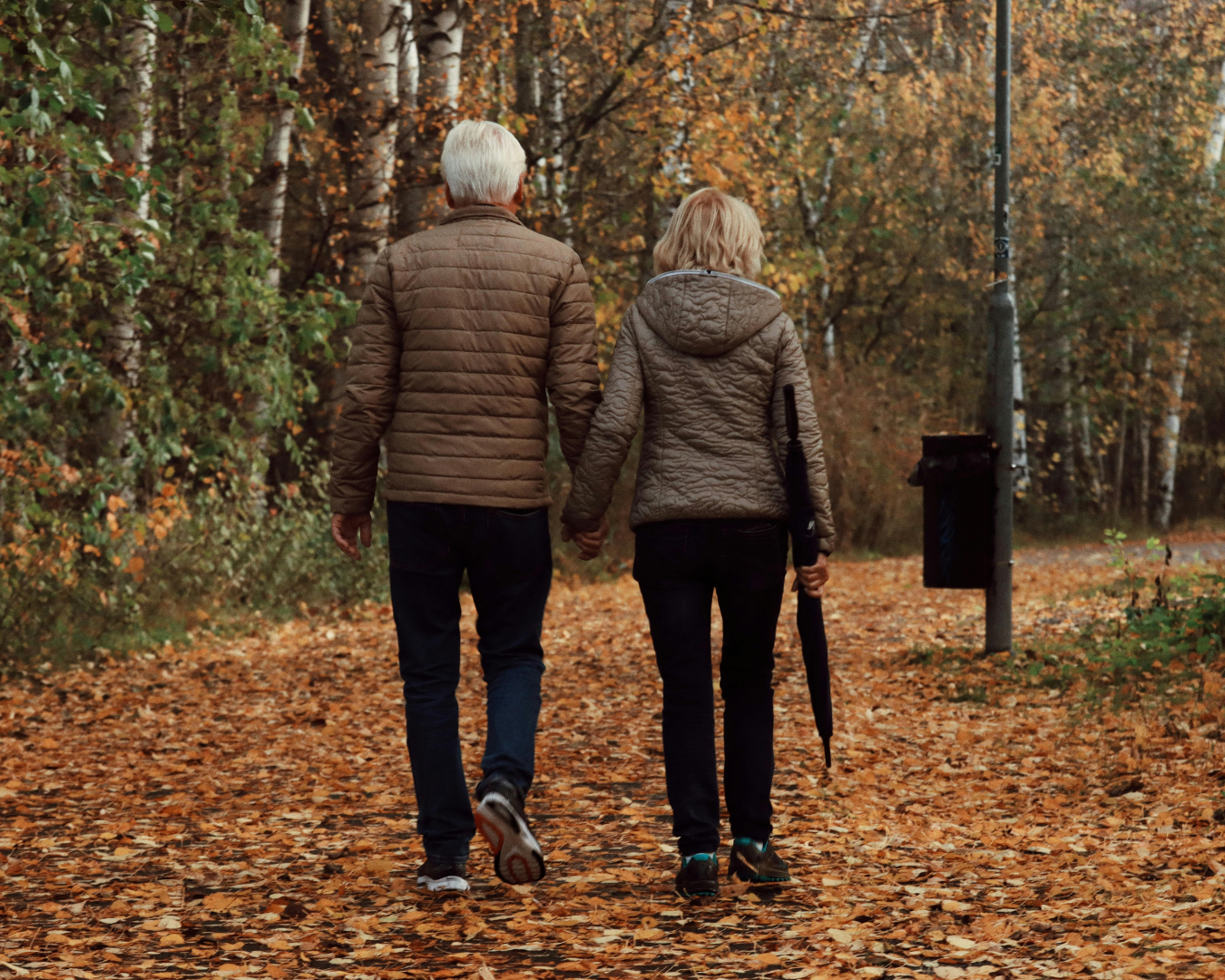 Iowan older couple walking in the park on a fall day.