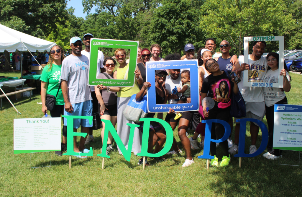 APDA Optimism Walk participants with photo frames and END PD sign