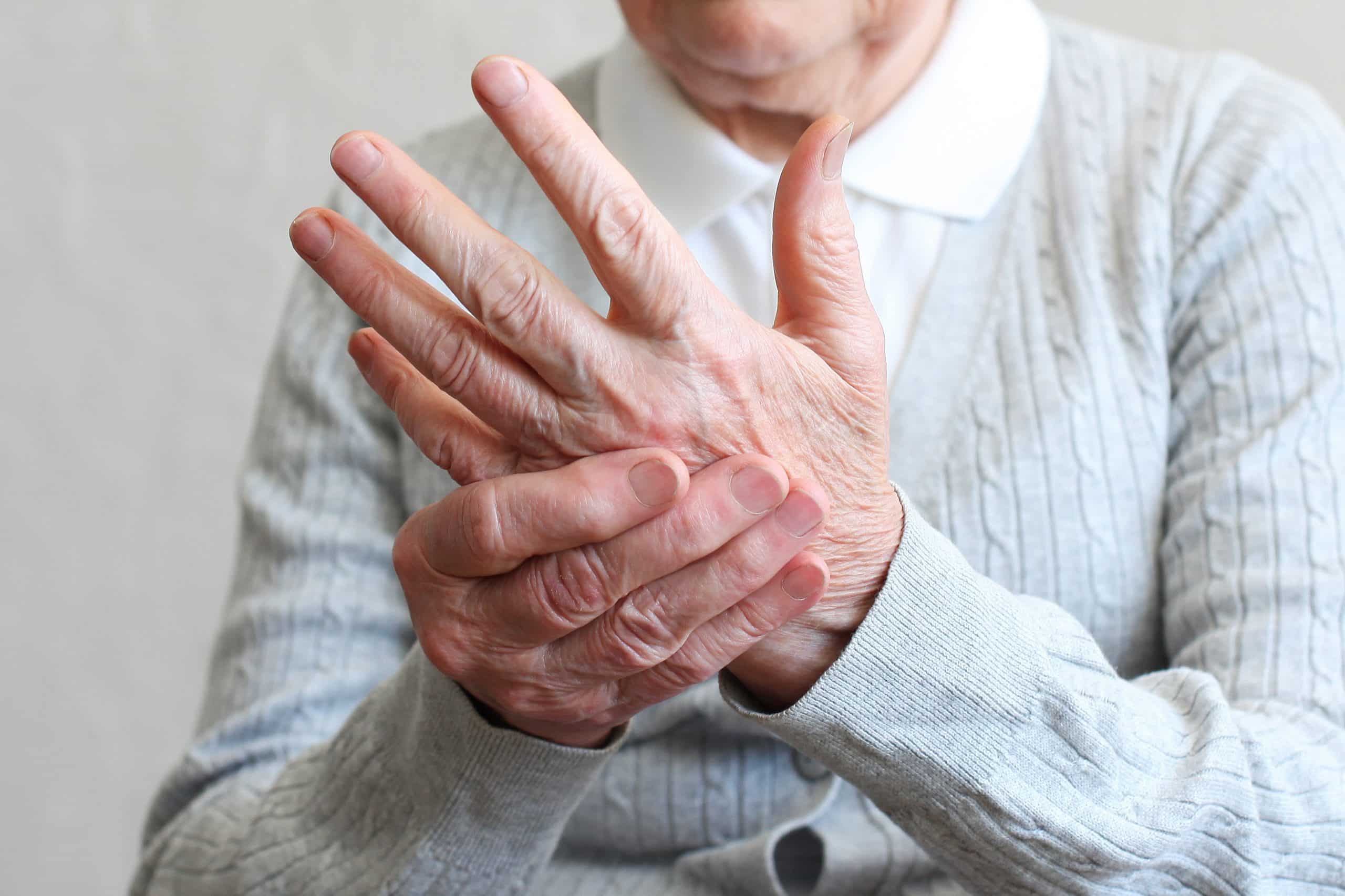 Elderly woman with tremoring hands