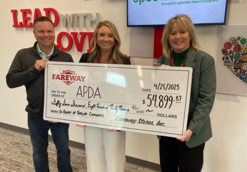 Foundations - 3 people holding large check.